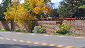 Exposed adobe privacy wall with tile cap