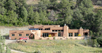 Southwest style sustainable compressed earth block house with pressed adobes made from site soil