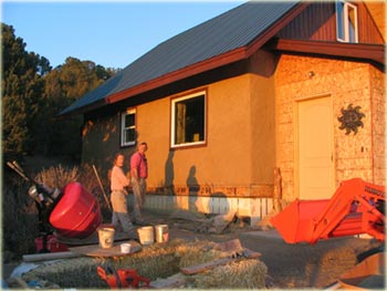 natural earth plaster on small straw bale house 