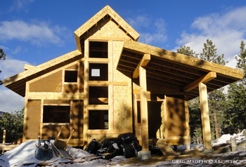 natural house utilizing reclaimed logs in Santa Fe, New Mexico