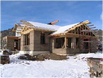 local lumber on rammed earth walls